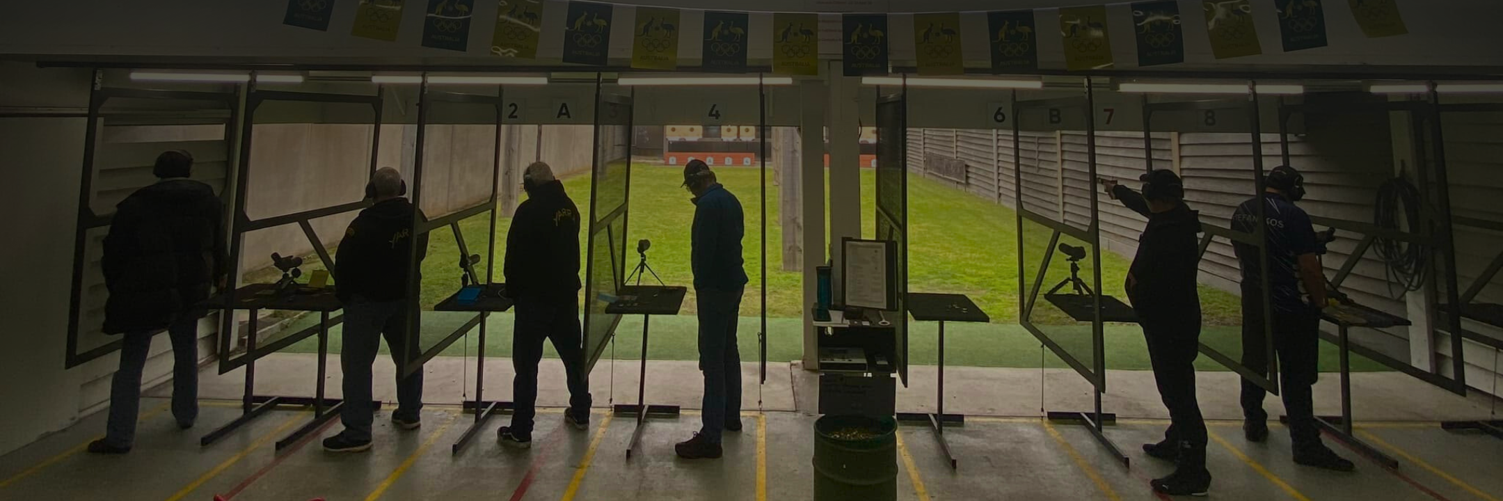 ISSF Pistol shooters competing in 25m centre fire on an outdoor range.
