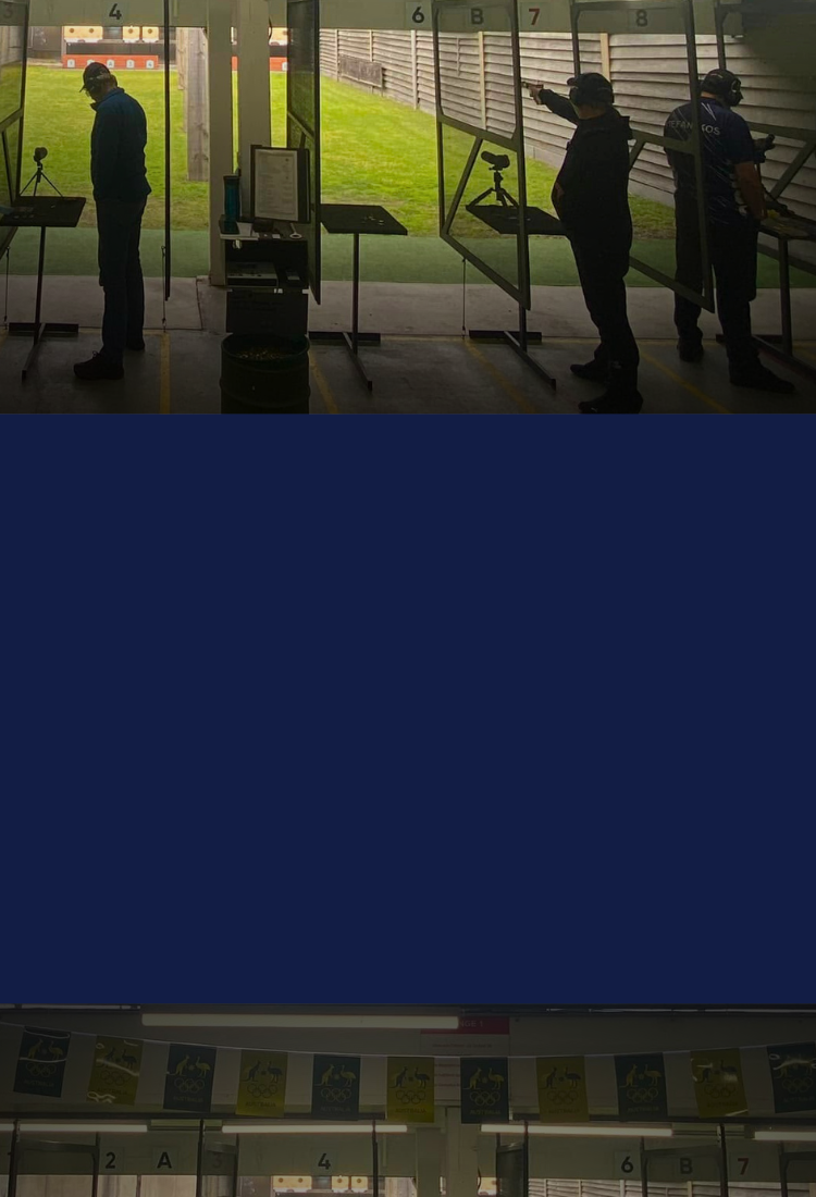 Male ISSF pistol shooters competing in 25m centre fire on an open range.