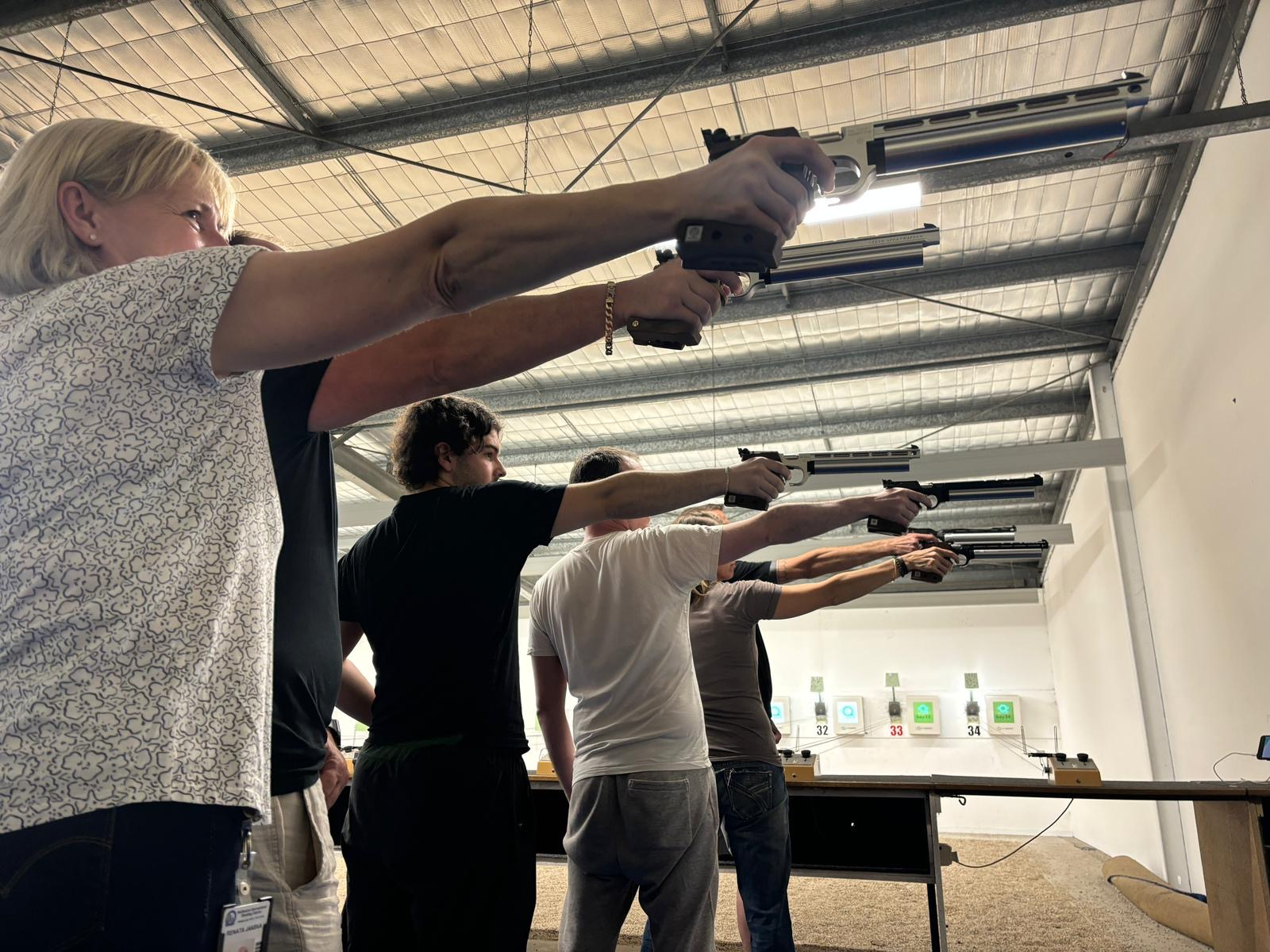 ISSF pistol shooters dry-firing air pistol in training drills. 